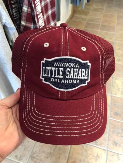 A maroon trucker hat featuring the text "Waynoka Little Sahara Oklahoma" on a patch.