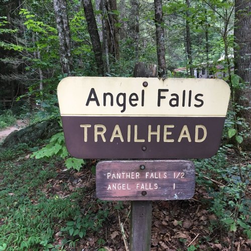 Sign for Angel Falls Trailhead, indicating directions to Panther Falls and Angel Falls in a wooded area.