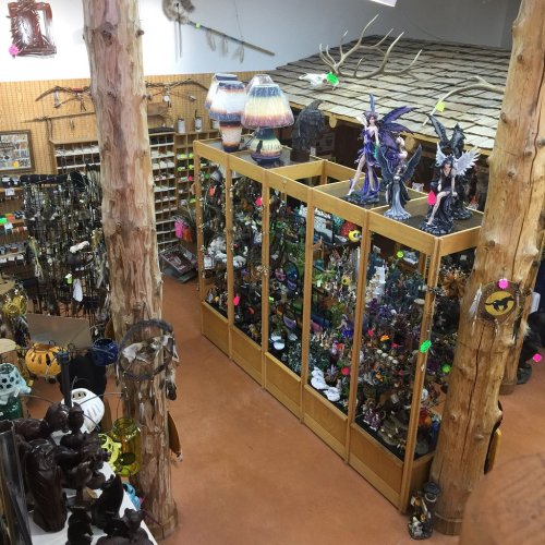 Aerial view of a craft store filled with various decorative items, sculptures, and lamps, surrounded by wooden pillars.