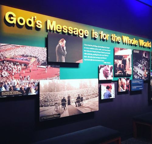 A colorful display featuring photos and text about spreading God's message to the world, with a large headline.