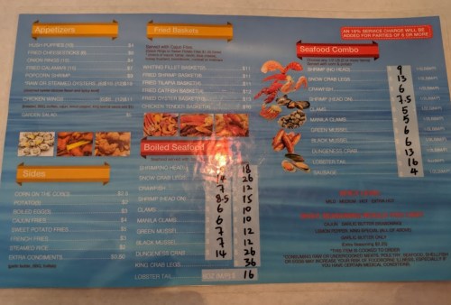 Menu featuring appetizers, fried baskets, boiled seafood, and sides with prices listed for each item.
