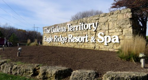 Sign for The Galena Territory Eagle Ridge Resort & Spa, featuring stone structure and landscaped area.
