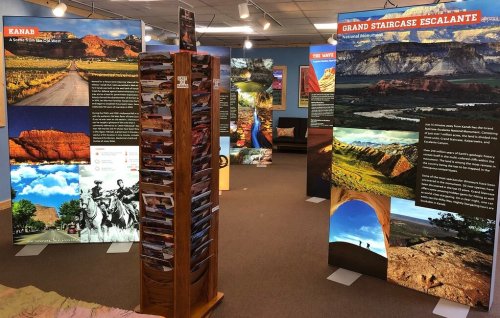 Exhibit featuring informational panels about Kanab and Grand Staircase-Escalante, with scenic images and a brochure stand.
