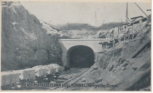 Black and white photo of the East Portal of Sylvan Hill Tunnel in Terryville, Connecticut, with railway tracks and construction.