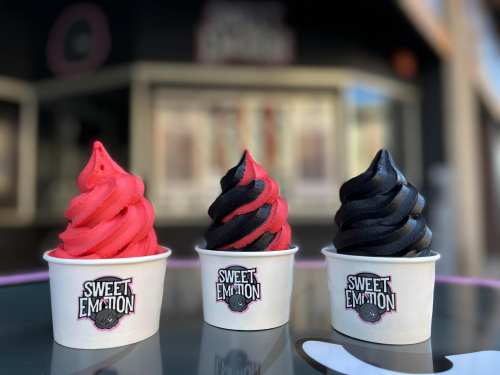 Three cups of soft serve ice cream: one red, one black, and one a mix of both, all labeled "Sweet Emotion."