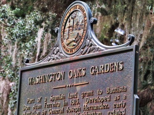 Historical marker for Washington Oaks Gardens, detailing its origins and development as a plantation.
