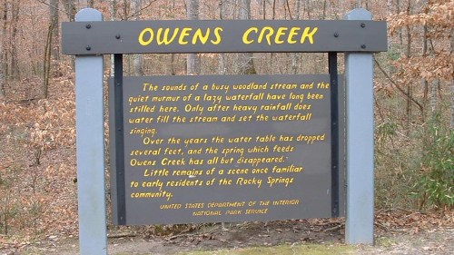 Sign for Owens Creek describing the sounds of the stream and its historical significance to the Rocky Spring community.