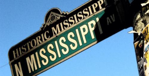 Street sign for "N Mississippi Ave" with a blue sky in the background.