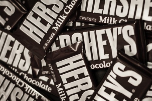 A close-up of multiple Hershey's Milk Chocolate bars stacked together.
