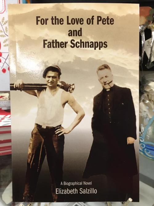 Book cover featuring a man with a barbell and a priest, titled "For the Love of Pete and Father Schnapps" by Elizabeth Salzillo.