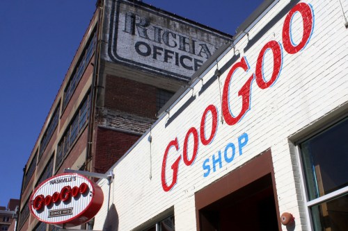 Exterior of the Goo Goo Shop with a vintage sign above, showcasing the shop's name and history since 1912.