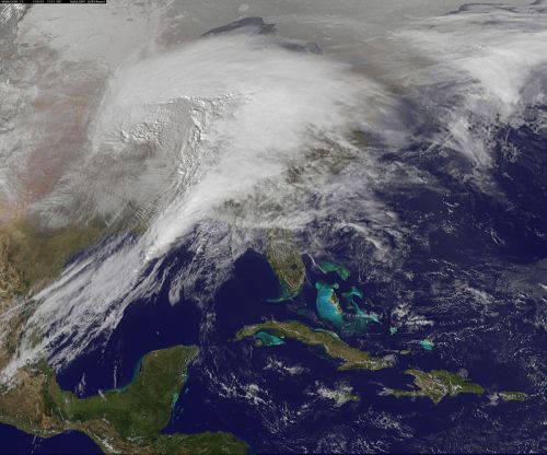 Satellite image showing a large weather system over the southeastern United States and the Caribbean Sea.