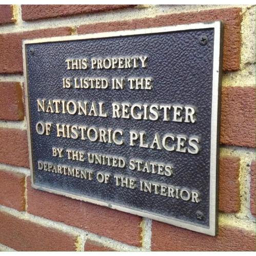 Plaque stating the property is listed in the National Register of Historic Places by the U.S. Department of the Interior.