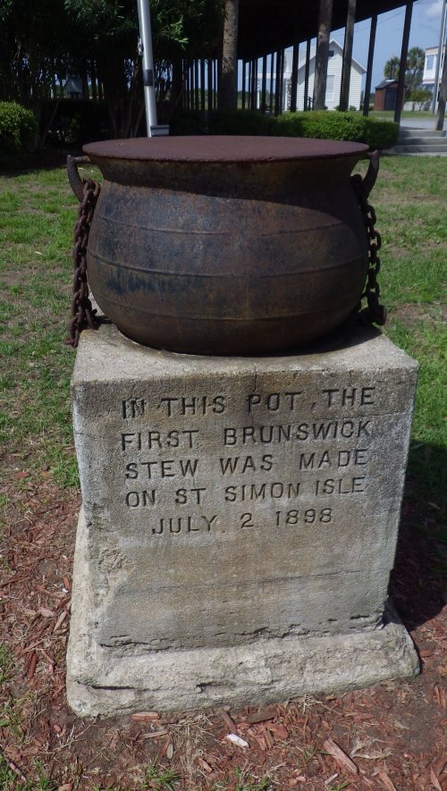 A historic pot on a stone pedestal, marking the site where the first Brunswick stew was made on St. Simon Isle, July 2, 1898.