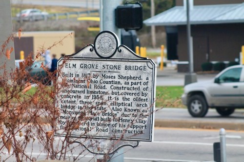 Historic sign for Elm Grove Stone Bridge, built in 1817, detailing its significance and construction history.