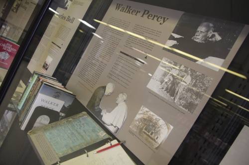 Display case featuring information about Walker Percy, including photos, books, and a biography.
