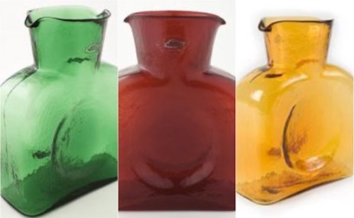 Three decorative glass vases in green, red, and amber colors, showcasing unique shapes and smooth surfaces.