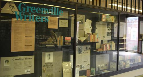 Display case featuring information and books about Greenville writers, including Caroline Stern and William Alexander Percy.