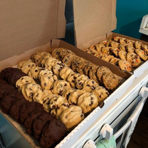 A box filled with various types of cookies, including chocolate chip, oatmeal, and peanut butter varieties.