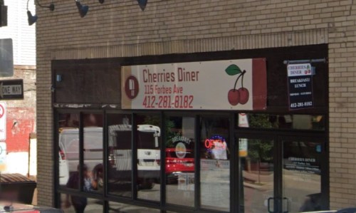 Exterior of Cherries Diner, featuring a sign with cherries and contact information, located on Forbes Avenue.