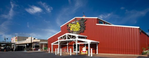 Red barn-style building with a sign reading "Southern Farms," under a blue sky with scattered clouds.