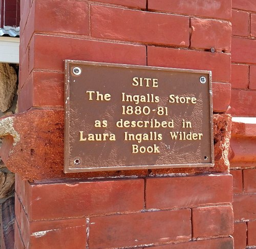 Plaque on a brick wall marking the site of the Ingalls Store (1880-81) from Laura Ingalls Wilder's book.