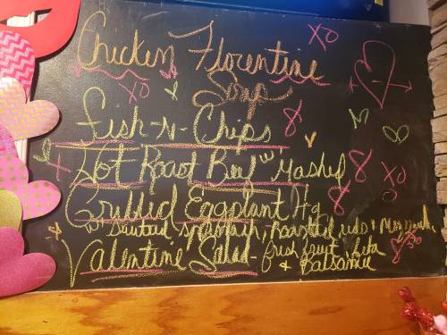 Chalkboard menu featuring Chicken Florentine, Fish & Chips, Hot Root Bay Mash, and Valentine Salad. Colorful handwritten text.