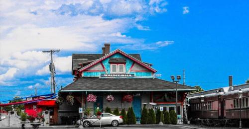 Historic train station in Waukesha, featuring colorful architecture and a clear blue sky.