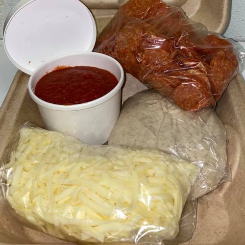 A takeout container with pepperoni, marinara sauce, shredded cheese, and two tortillas.