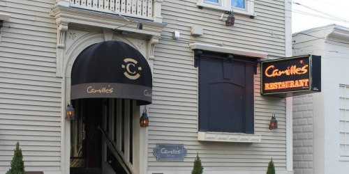 Exterior of Camille's Restaurant featuring an awning and illuminated sign, with a welcoming entrance.