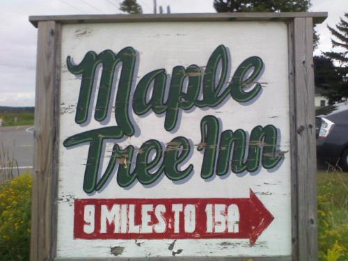 Sign for Maple Tree Inn, indicating it's 9 miles to Route 15A, with a directional arrow.
