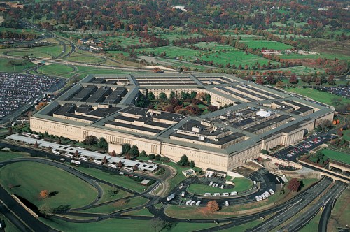 Aerial view of the Pentagon, surrounded by roads and greenery, showcasing its distinctive five-sided structure.