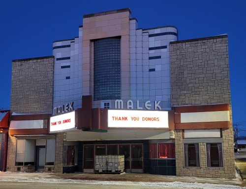 The Malek Theater building at dusk, featuring a marquee that reads "Thank You Donors." Snow on the ground.