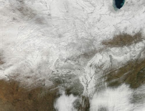Satellite image showing a snowy landscape across the Midwest, with visible rivers and varying terrain.
