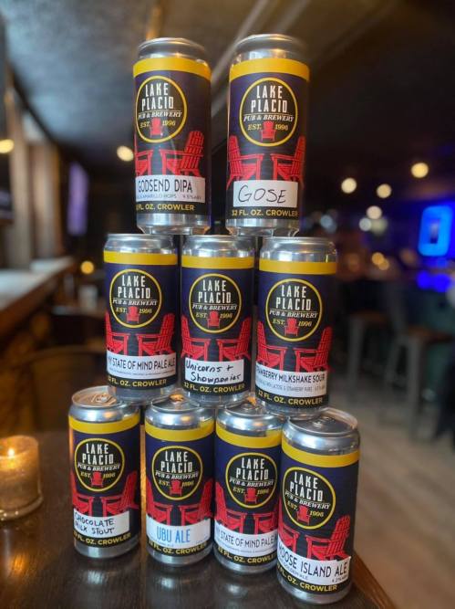 A stack of colorful beer cans from Lake Placid Brewery, featuring various styles like DIPA, Gose, and Milkshake Sour.
