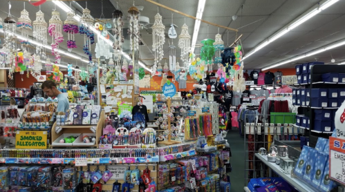 A colorful store interior filled with various merchandise, including toys, clothing, and decorative items.