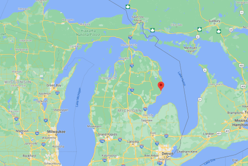 Map of Michigan highlighting a specific location near the center of the state, surrounded by lakes and forests.