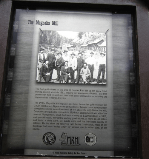 Historical photo of miners at Magnolia Mill, with text about its significance in the Snow Blind Mining District.