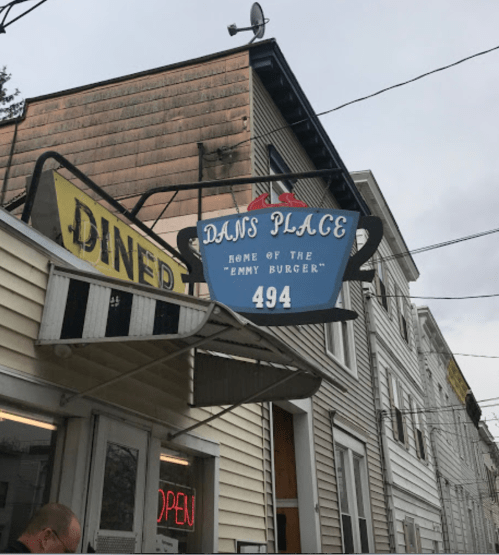 Sign for Dan's Place, featuring "Home of the Emmy Burger," located at 494, with a diner-style exterior.