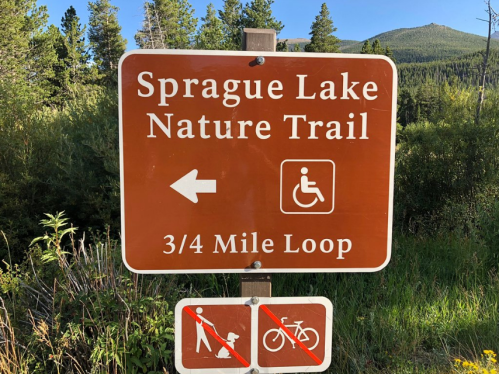 Sign for Sprague Lake Nature Trail, indicating a 3/4 mile loop, with directions for accessibility and no dogs or bikes allowed.