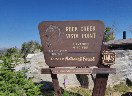Sign for Rock Creek Vista Point, elevation 9,190 feet, in Custer National Forest, with scenic view information.