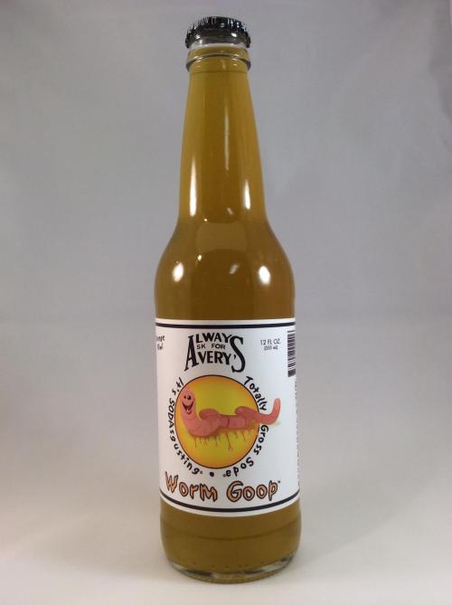 A bottle of "Worm Goop" soda with a cartoon worm on the label, featuring a yellowish liquid inside.