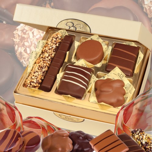 A luxurious box of assorted chocolates, featuring various shapes and toppings, elegantly presented.