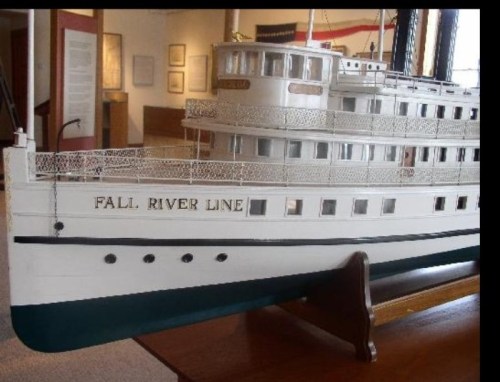 Model of a historic steamboat named "Fall River Line," displayed in a museum setting.