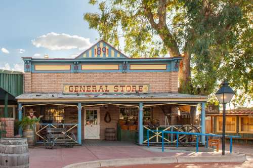 Historic general store with a brick facade, wooden accents, and a sign reading "General Store" under a blue sky.