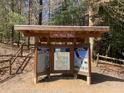 Information kiosk for Lyons Falls Trail, featuring maps and details about local wildlife and hiking routes.