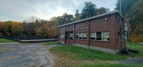 A brick building labeled "Bear Hole Pumping Station" surrounded by trees with autumn foliage.