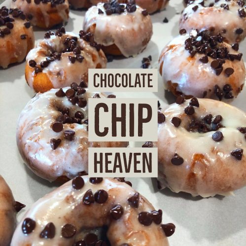 A close-up of glazed donuts topped with chocolate chips, with the text "Chocolate Chip Heaven" overlaying the image.
