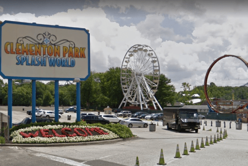 Welcome sign at Clement Park Splash World, featuring a ferris wheel and a roller coaster in the background.