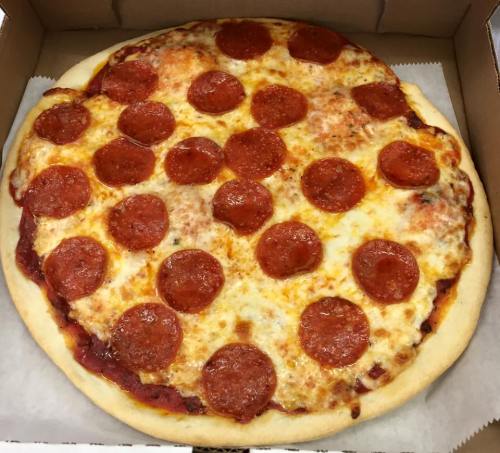 A freshly baked pepperoni pizza with melted cheese, arranged with slices of pepperoni on a golden crust.